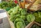 Cabbages and the lettuces in the wooden boxes in the market for sale