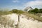 Cabin cottage small house on ocean seashore in grass and sand on a bight sunny day