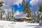 Cabin Covered In Snow At Top Of Hill