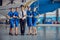 Cabin crew of a commercial airplane looking and smiling at the camera