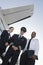 Cabin Crew Members Standing Together At Airfield