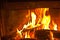 Cabin fireplace with burning logs in fireplace,