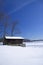 Cabin on frozen lake