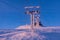 The cabin lift at Snezka, the lifts of the cable car and the winter landscape lit by the sunset in the beautiful colors of the win