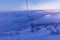 The cabin lift at Snezka, the lifts of the cable car and the winter landscape lit by the sunset in the beautiful colors of the win