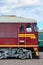 Cabin of modern Russian electric train. Side view of the head of railway train with a lot of wheels and windows in the form of po