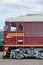 Cabin of modern Russian electric train. Side view of the head of railway train with a lot of wheels and windows in the form of po