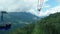 Cabin of ropeway passes over mountains