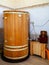Cabinet for cosmetology procedures, rest and recovery with wooden phyto barrels for spa, wellness and skin care and human figure.