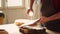 Cabinetmaker in assembly shop lacquering wooden board, close up