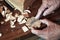 Cabinetmaker\'s hands using rasp on a piece of wood