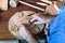 Cabinetmaker\'s hands using sandpaper on a piece of wood