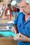 Cabinetmaker sanding a decorative piece of wood