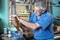 Cabinetmaker working with plane in the bench in garage at home