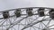 Cabins Ferris Wheel rotating on a cloudy sky background.