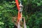 Cable bridge in the mountains with tied colored ribbons and other tinsel