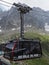 Cable car cabin with tourists on AIGUILLE DU MIDI at high french mountain range landscape at european ALPS - vertical