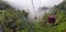 Cable car at genting highlands, malaysia in a foggy weather with green grass visible from inside cable car