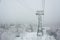 Cable car gondola lift pillar pole with cables to the track on a slope for skiing on Mount Asahi Asahidake mountain