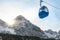 Cable car and snow-capped mountains