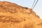 Cable car to ruins of palace and fortress Masada on Judaean Desert rock plateau, Israel