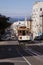 Cable car on top of a San Francisco Hill with bay water in background