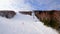 A cable car that transports skiers and snowboarders on a winter slope. On a sunny winter day in a ski resort, the lift