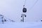 Cable cars going up and down snow blanketed slopes of the mountain while a snow storm building up. Mt Ruapehu, Whakapapa