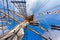 Cable ladders, mast and ropes of a sailing ship against the blue sky. Concept of travel, adventure and sea.