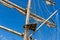 Cable ladders, mast and ropes of a sailing ship against the blue sky. Concept of travel, adventure and sea.