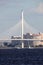 Cable-stayed bridge against the backdrop of urban residential buildings on the shores of the Gulf of Finland