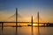 The cable-stayed bridge over Petrovsky fairway and the tower of Lakhta center, at sunset, Saint-Petersburg