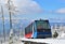 Cableway cabin on rails in mountains in a sunny day