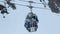 Cableway cabins moving fast, transporting skiers and snowboarders to skiing run