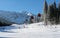 Cableway cabins and skiers on a sunny day on the slopes of the J