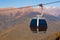 Cableway on mountains background in autumn season