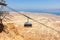 Cableway from rock top of  Fortress Masada 1st century. Cable car over Judaean Desert. Dead Sea coast. Herod the Great palace