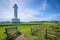 Cabo de Lastres lighthouse in Luces-Colunga, in Asturias (Spain), with a wooden bench in the foreground