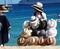 Cabo San Lucas, Mexico - November 7, 2022 - A local salesperson offering hats for sale on the beach