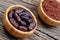 Cacao beans with powder in a bamboo bowls on table