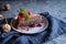 Cacao sponge cake with poppy seeds and coconut filling, decorated with freeze - dried raspberries