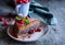 Cacao sponge cake with poppy seeds and coconut filling, decorated with freeze - dried raspberries