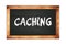 CACHING text written on wooden frame school blackboard