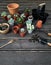 Cactus transplantation in a new pot with soil, pumice stone, drainage, shovel rake, pot on wooden floor.