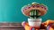 A cactus wearing a sombrero and mustache