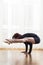 Cacuasian Woman Doing Yoga Tittibhasana Posture Indoors