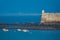 Cadiz fort near ocean in a misty day with blurred city