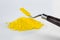 Cadmium Yellow pigment on a white background