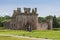 Caerlaverock Castle in green under blue sky, Scotland UK.