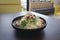 Caesar salad in black bowl on the dark background